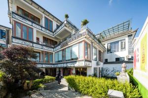 a large white building with a lot of windows at Floral Hotel Dali Ershuang Sea View in Dali