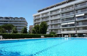 a large swimming pool in front of a building at Comfy flat with terrace 250mt from the sea in Porto Santa Margherita di Caorle