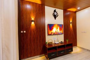 a living room with a fire in the wall at Your Kigali Base a 2 Bedroom with Kitchen and Private Parking in Kigali