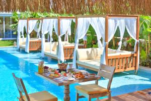 a table with food on it next to a pool at Kose Konak Butik Hotel-Special in Alacati