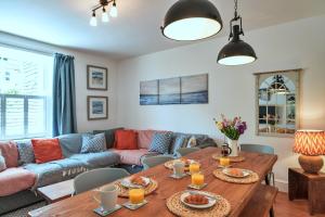 a living room with a couch and a table at Finest Retreats - Woodleigh, Cawsand in Cawsand +20 photos