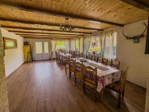 a dining room with tables and chairs in a building at Casa Luna Șirnea in Şirnea