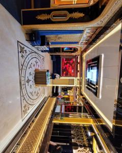 a long hallway with gold and black floors and ceilings at Camphor Hotel in Ras al Khaimah