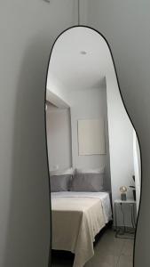 Thérissosにある3 Gracesの白い部屋のベッドを反映する鏡