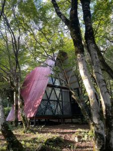 a cabin in the woods with a red roof at Zen in Sataplia 