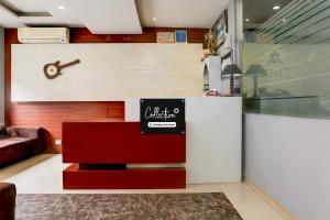 a room with a counter with a clock on the wall at Super Collection O Railway Station Road Near Clock Tower in Ludhiana