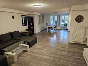a living room with a couch and a table at 2 Zimmer Apartment am Zoo mit Garten in Wuppertal