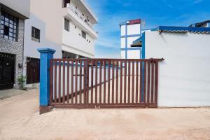 a wooden gate in front of a white building at Super OYO Hotel O Varanasi Banaras Junction Formerly Girija Palace in Varanasi +38 photos
