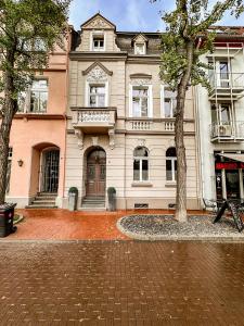 a large building with a tree in front of it at Kastell3 Boutique Apartments in Moers