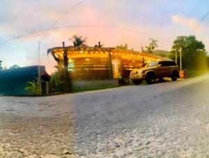 a truck parked in front of a building with lights at e34 Café, Restaurant & Hotel Koslanda Hideaway with a Private Natural Pool in Koslanda