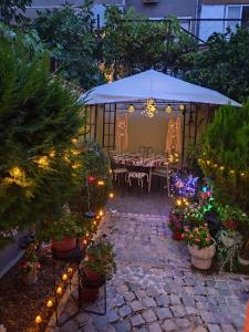 a patio with a table and some plants and lights at Cozy apartment for overnight stays Hristo Smirnenski in Plovdiv