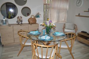 a dining room with a glass table and chairs at Cozy apartment for overnight stays Hristo Smirnenski in Plovdiv