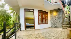 a door leading to a bedroom in a house at e34 Café, Restaurant & Hotel Koslanda Hideaway with a Private Natural Pool in Koslanda