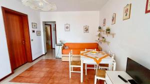 a living room with a table and a couch at Alba sul Mare Apartments in Ali Terme