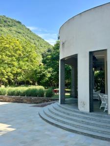 a building with stairs in front of a mountain at Surya Bagh - A Luxury Hideaway - 5 minutes to Ajabgarh, 10 minutes to Bhangarh & 20 minutes to Tehla, Sariska in Ajabgarh