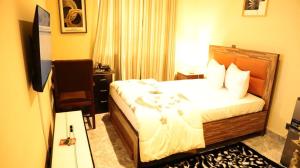 a hotel room with a bed and a television at De GraceManuel Terrace 