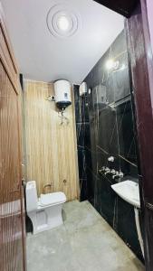a bathroom with a toilet and a sink at maya guest house in Calangute