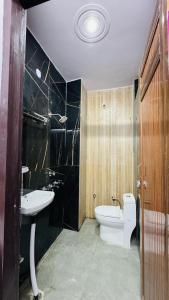 a bathroom with a toilet and a sink at maya guest house in Calangute