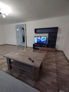 a living room with a coffee table and a flat screen tv at Guest House in Gyumri