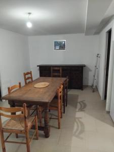 a dining room with a wooden table and chairs at appartement gites a la ferme in Barbentane +6 photos