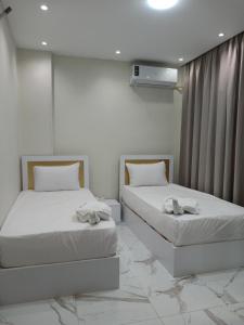 a bedroom with two beds with towels on them at Golden Ibis Memphis in Cairo +21 photos
