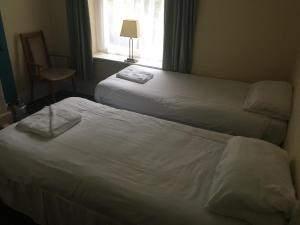 
a bedroom with a bed and a lamp in it at Four Seasons Budget in Aberystwyth
