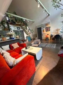 a large living room with red couches and a table at FiillhouseDilijan in Dilijan