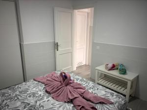 a bedroom with a bed with a towel on it at Puerta del Sol Caleta Fuste (Fuerteventura) in Caleta De Fuste +12 photos
