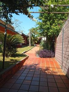 a brick walkway in front of a house at Caprichos de la Selva Puerto Iguazú in Puerto Iguazú