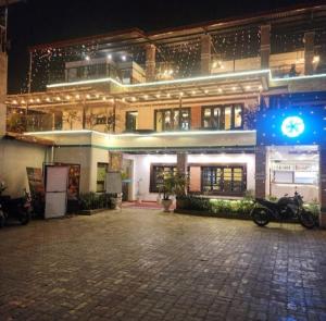 a building with a motorcycle parked in front of it at President Boutique Hotel in Pashupatināth