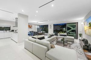un soggiorno con mobili bianchi e una cucina di Villa Costa a Hollywood