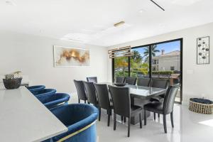 a dining room with a table and chairs at Villa Sienna Coastal Warmth in Hollywood