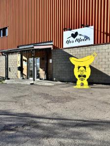 a large yellow statue in front of a building at Frost Longstay Lakeside in Kiruna +3 photos