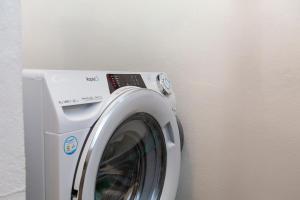 a washing machine sitting next to a wall at A28 - Castela Street Townhouse in Espiche in Luz