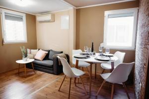 a living room with a table and chairs and a couch at Holiday home Pandora in Brežice