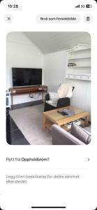 a living room with a couch and a coffee table at Litla Hyttå, Mosterhamn Bømlo in Mosterhamn +4 photos