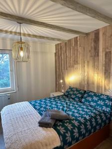 a bedroom with a bed with a blue comforter at Apartamentos La Pinilla in La Pinilla