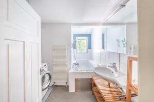 a bathroom with a sink and a washing machine at Casa Verde Dornbirn in Dornbirn +75 photos