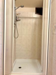a bathroom with a shower with a tub at La Torretta del Sementone in Assisi +9 photos