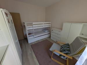 a small room with a refrigerator and a chair at Modern Apartment in Sofia Near City Center in Sofia