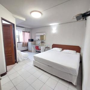 a bedroom with a large white bed in a room at BaanSathorn21 in Bangkok