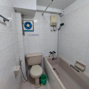 a bathroom with a toilet and a bath tub at BaanSathorn21 in Bangkok +8 photos