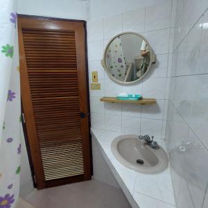 a bathroom with a sink and a mirror at BaanSathorn21 in Bangkok