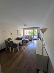 a living room with a table and chairs and a couch at Modern Apartment in Sofia Near City Center in Sofia