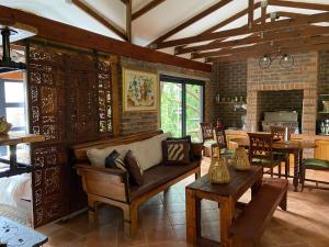 a living room with a couch and a table at Rosetta River Retreat in Mooiriver