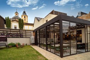 an extension to a building with large glass doors at Hotel Smrž in Sepekov