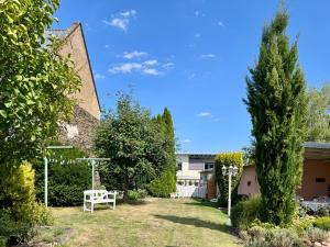 a garden with a white bench and trees at Auszeit zwischen Mosel und Nürburgring in Kehrig