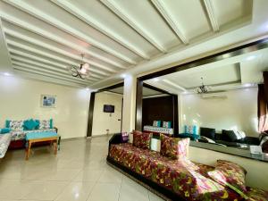 a living room with a couch and blue chairs at Luxury apartment Fes centre ville - Family & Friendly in Fès