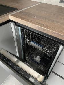 an open microwave oven with a wooden counter top at Dreams home in Uzhhorod +8 photos