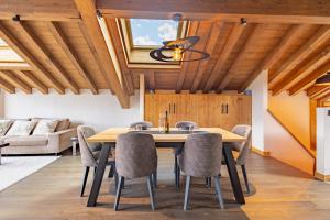 a dining room with a wooden table and chairs at Chalets Killington #4 - 4 guests in Les Allues +23 photos
